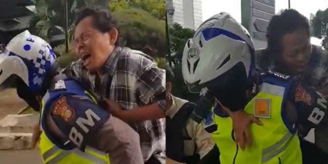 Salut, Polisi Ini Bantu Menggendong Seorang Bapak yang Terkena Serangan Jantung Dadakan