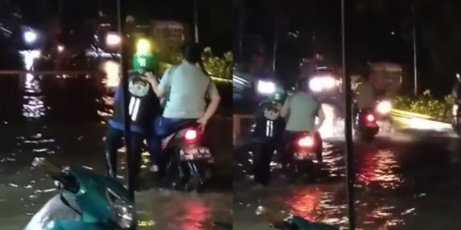 Meski Banjir Menghadang, Driver Ojol Ini Dorong Motornya dengan Penumpang Tetap Duduk