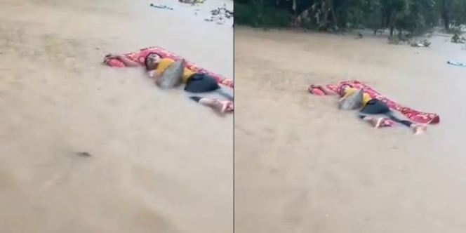 Penat, Pria Ini Santuy Banget Tidur di Atas Genangan Banjir
