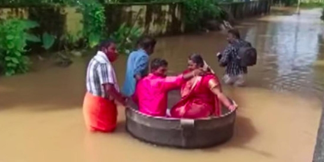 Nekat Terjang Banjir Demi Jalani Pernikahan, Pengantin di India ini 'Kendarai' Panci Besar!
